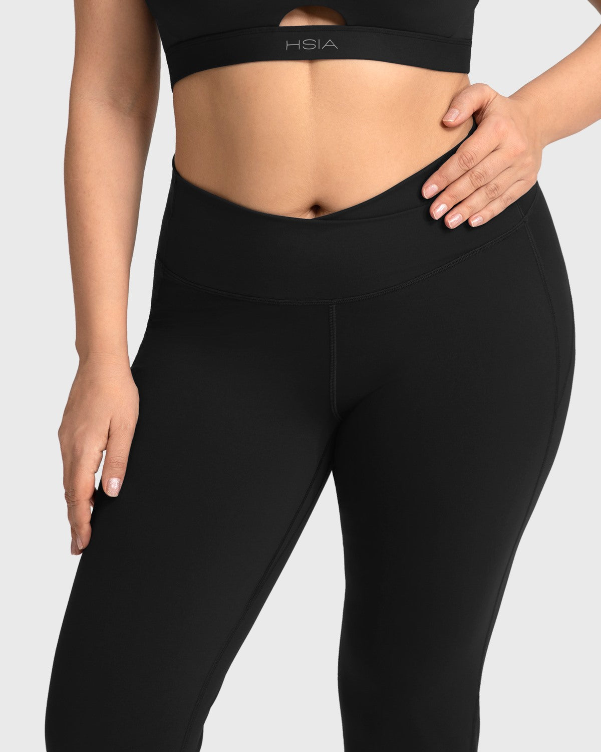 Close-up of the black cooling workout leggings, showcasing the premium moisture-wicking fabric and seamless crossover front.