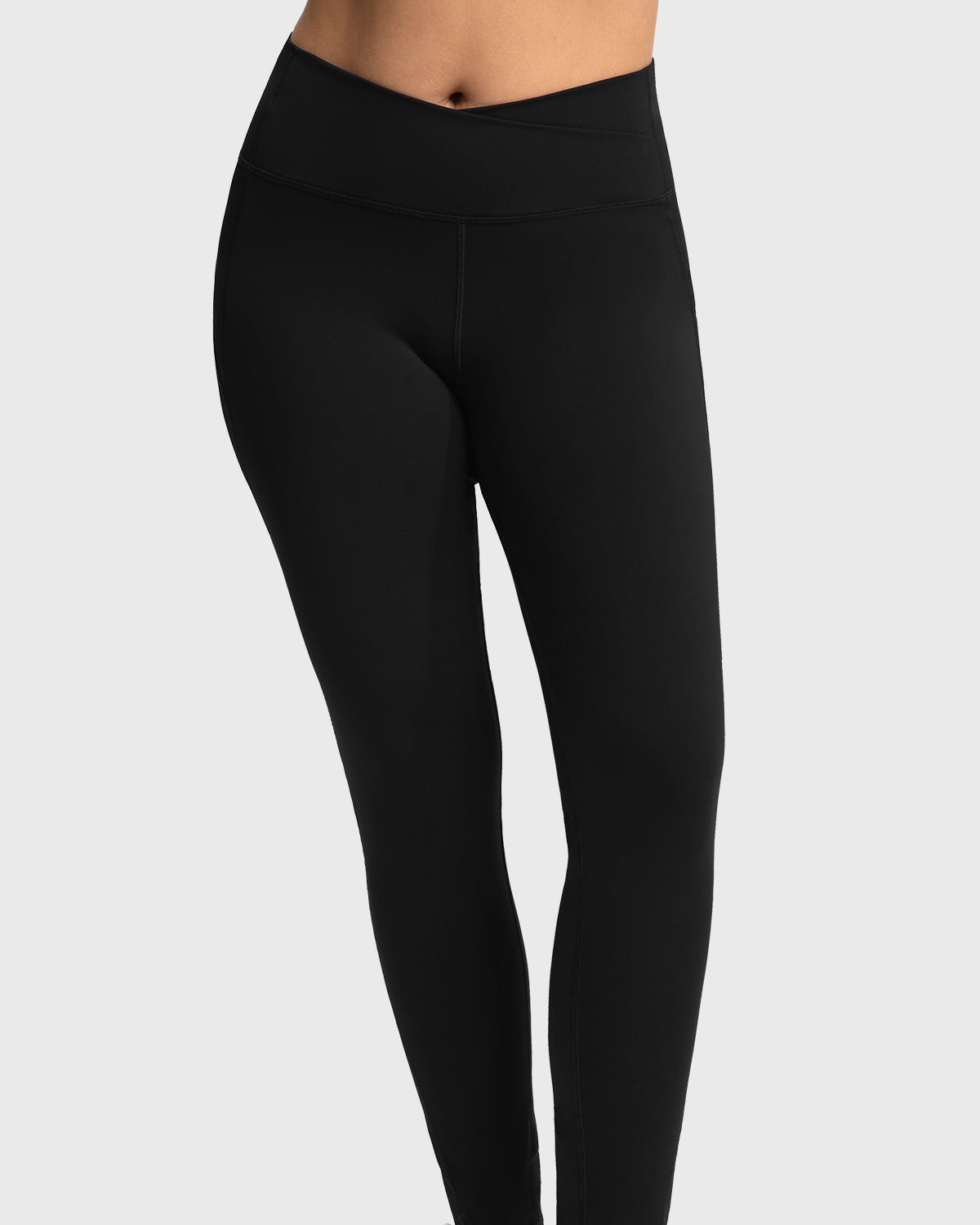 Front view of the black crossover high-waisted yoga pants, highlighting the stylish V-waist design that elegantly elongates the legs.