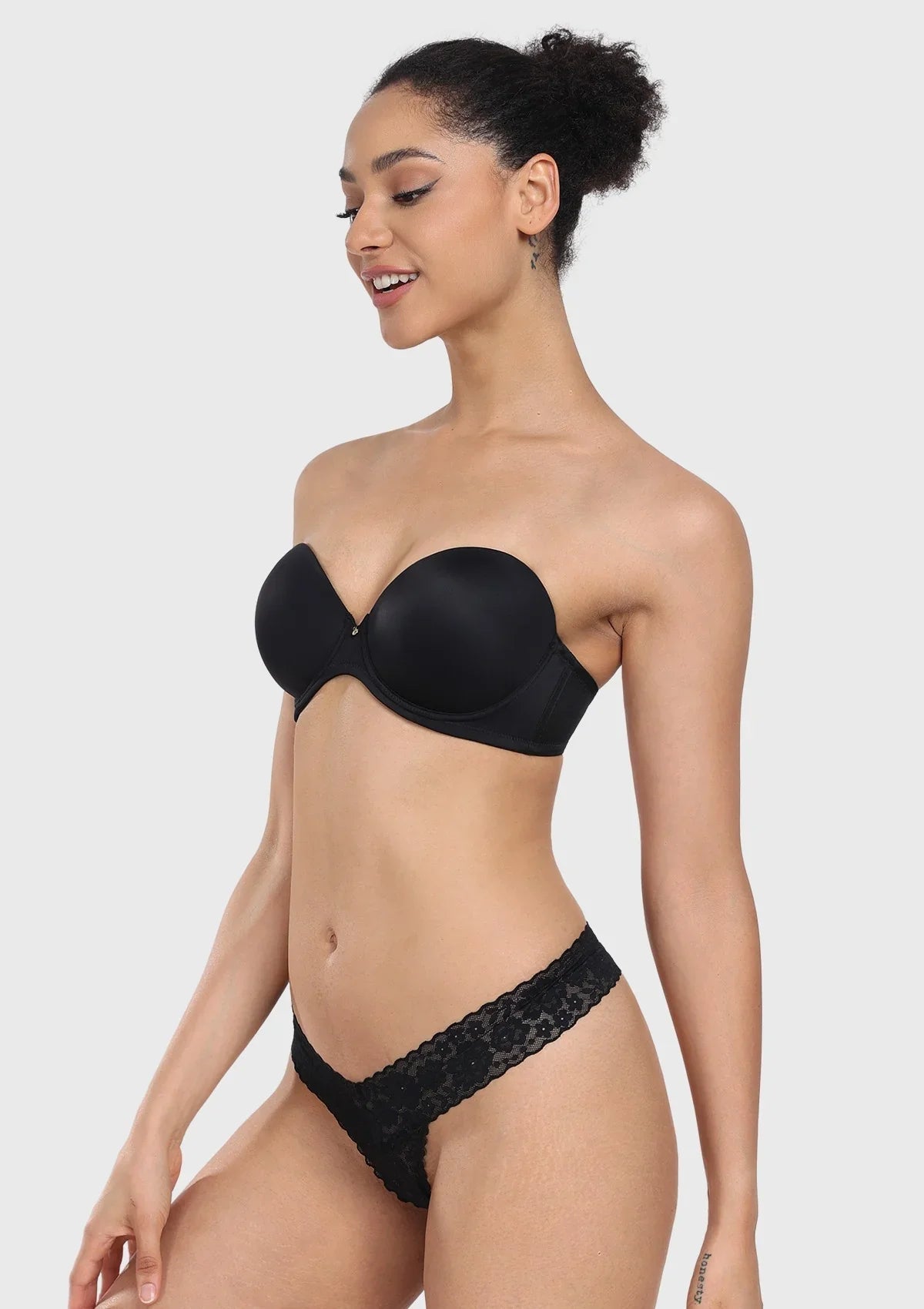 Three-quarter view of the black lightly lined underwire bra, utilizing a tailored balcony cup design to center and shape the breasts.
