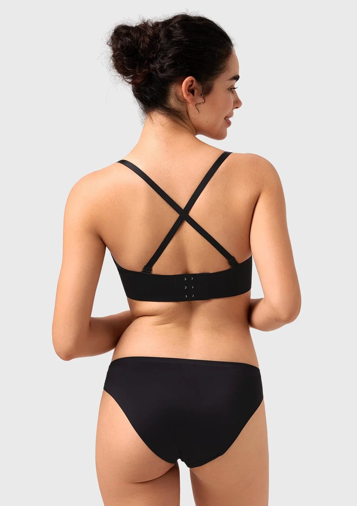 Back view of the black multiway bra configured with crisscross straps, providing a secure, stylish fit for active days or tricky dress backs.
