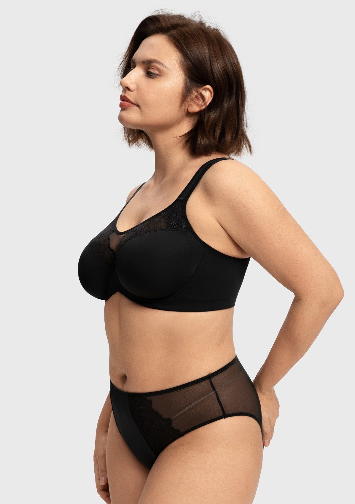 Three-quarter side view of the black plus size unlined bra, expertly engineered to offer a lightweight, natural, and rounded lift without bulky padding.
