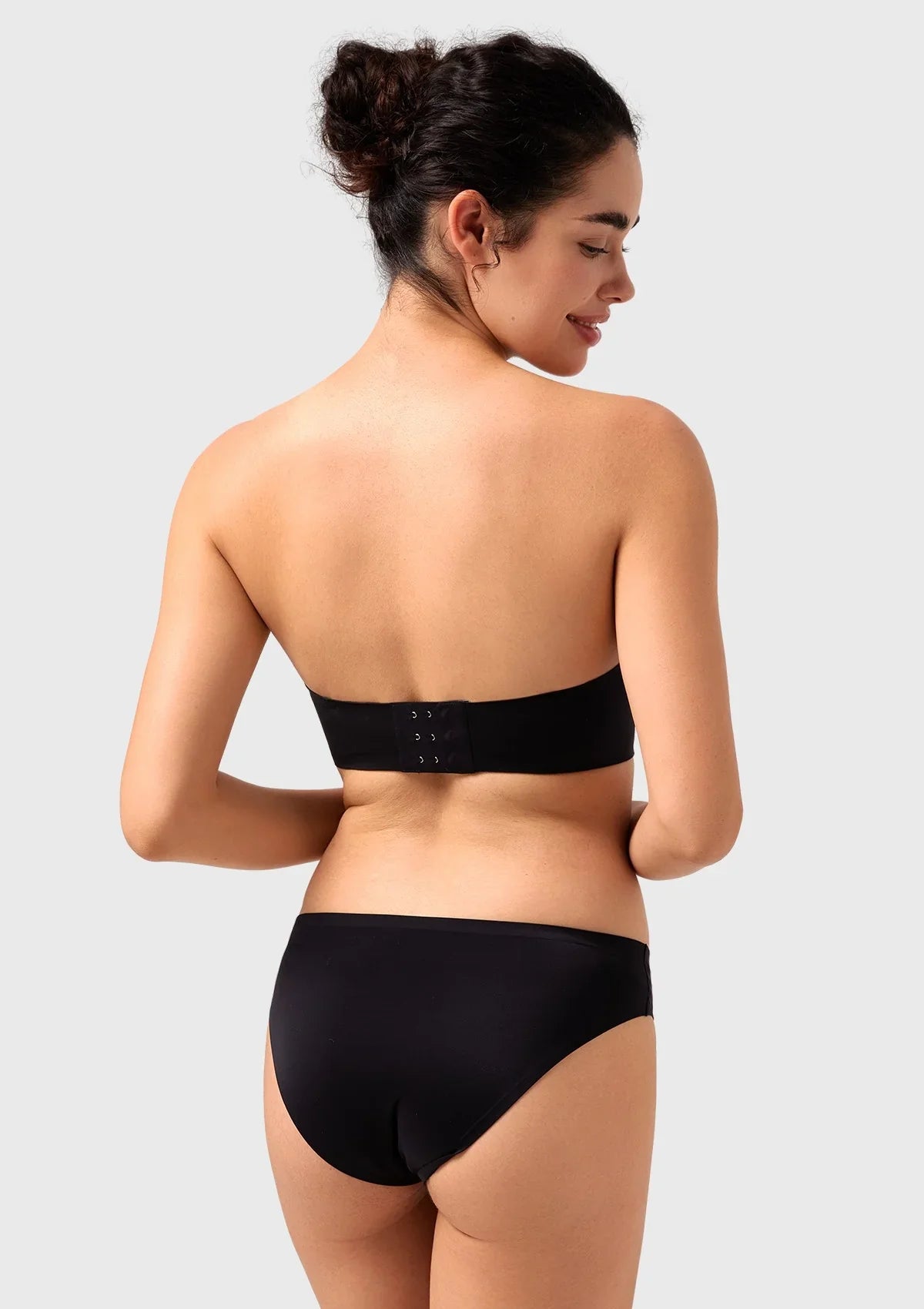 Back view of the black seamless back strapless bra, showcasing the comfortable, stretch-to-fit band for a flawless, bulge-free silhouette.