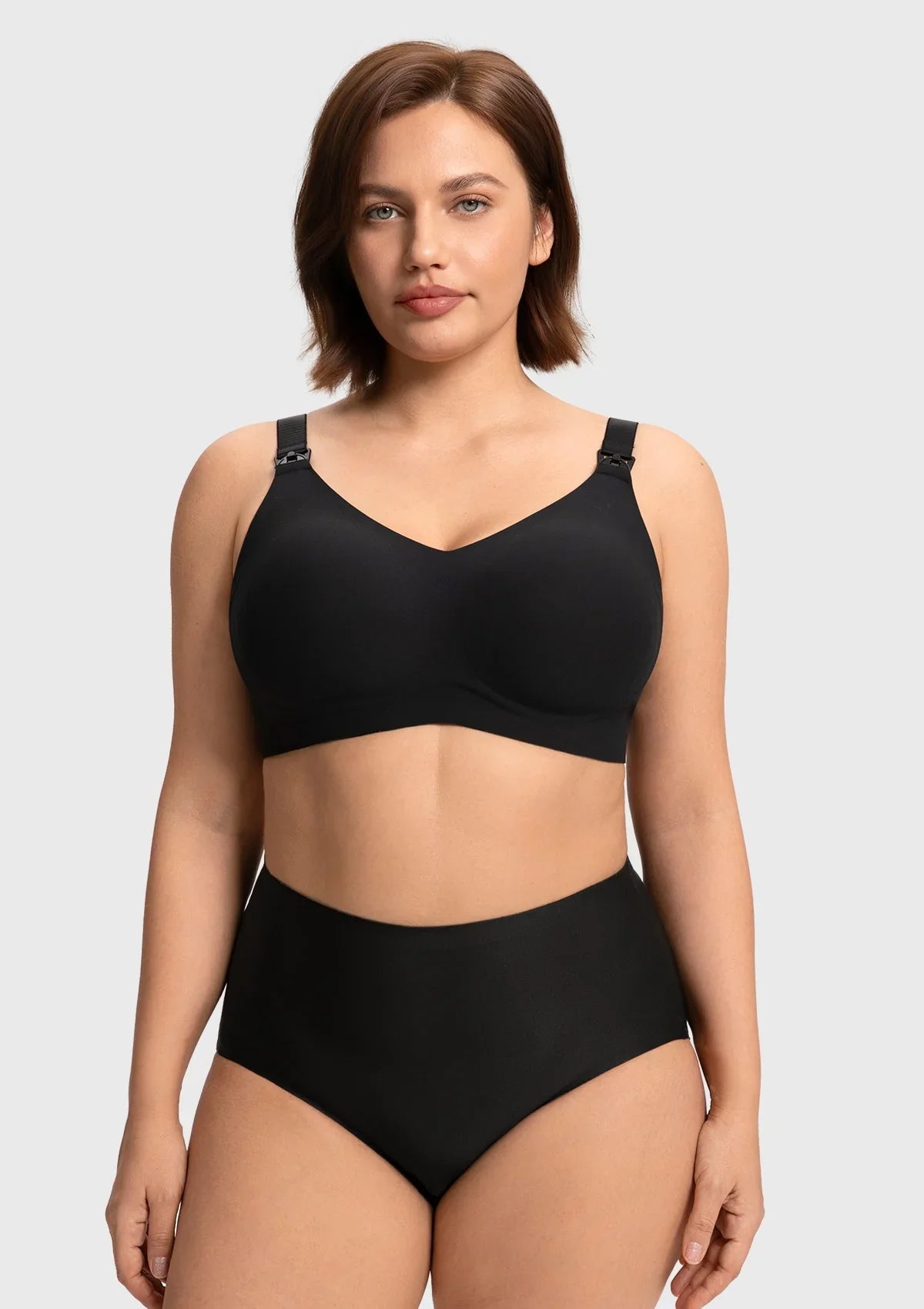 Front view of a model wearing the black SoftContour wireless nursing bra, showing the stylish V-neck design and smooth invisible fit under clothing.