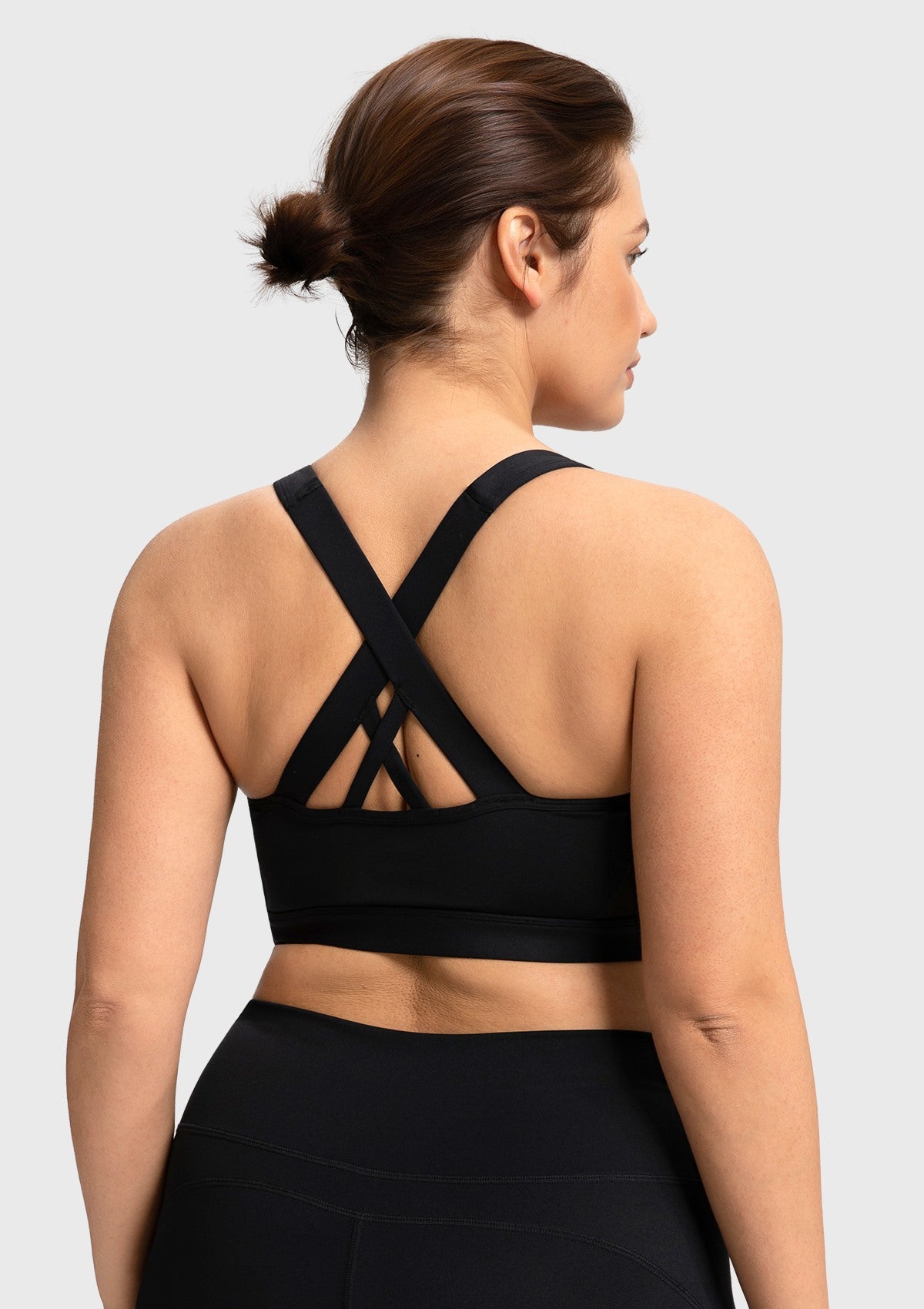 Back view of the black yoga bra featuring elegant criss-cross straps for unrestricted movement