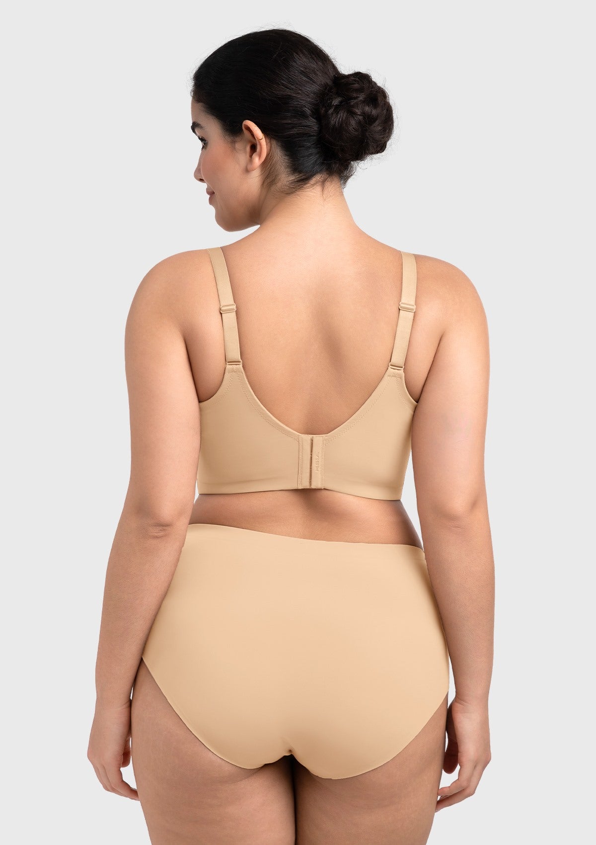 Rear view of the beige longline bra, featuring an extended back wing that smooths out bra bulge and back fat.