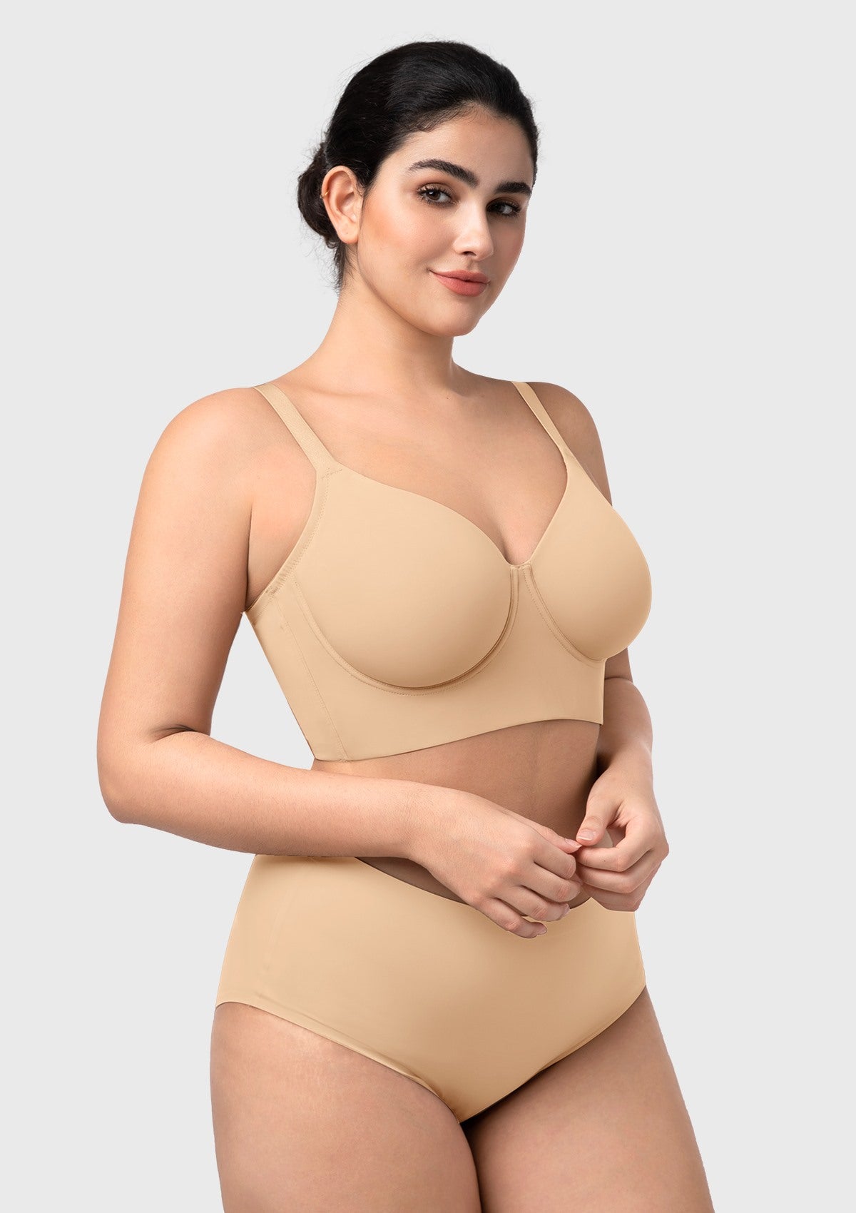 Side profile of the beige seamless longline bra, highlighting the hidden side-slings for a centered, youthful shape.