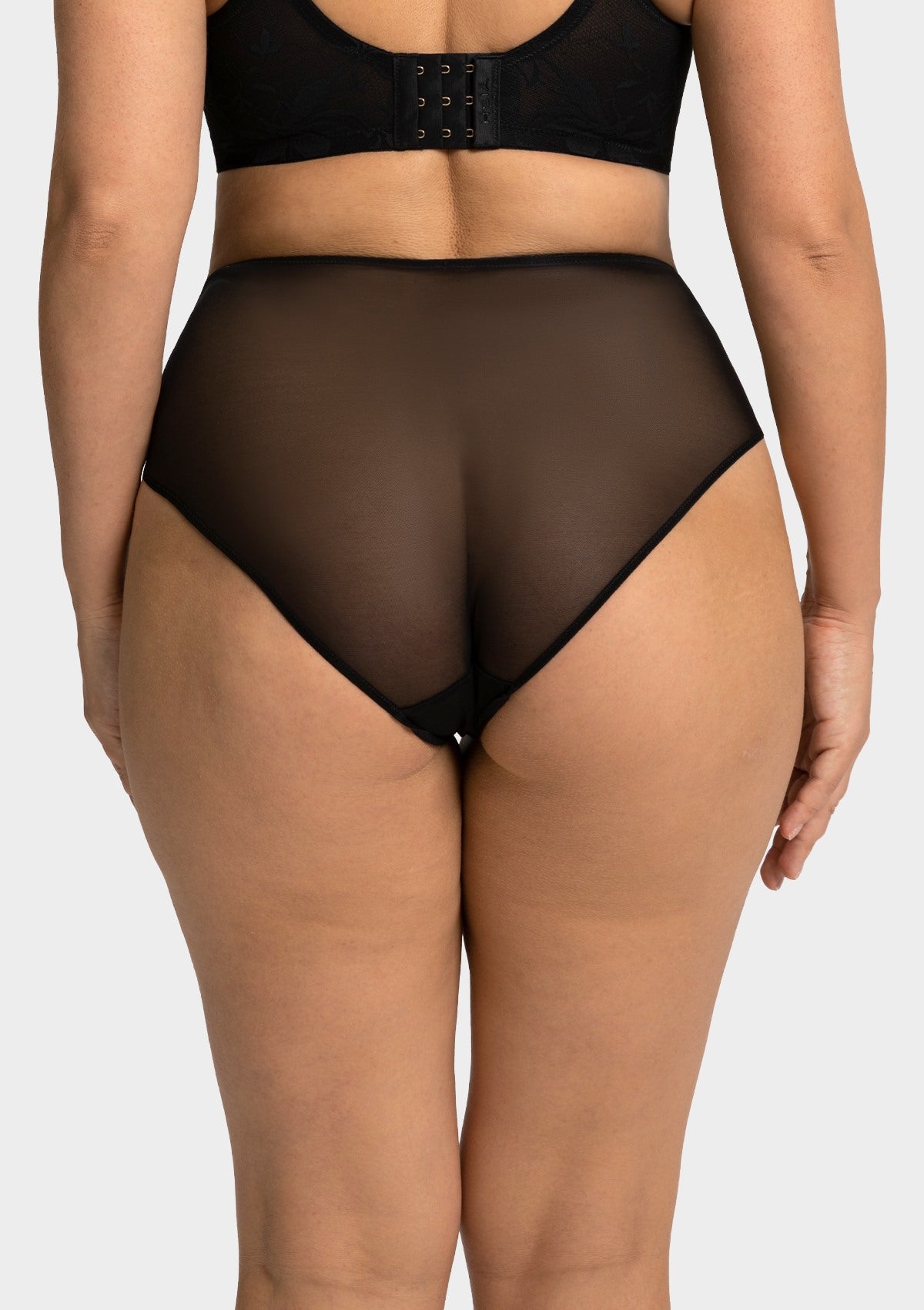 Rear view of the black Petalia full coverage panty, offering a seamless, pressure-free fit that flatters mature curvy shapes.