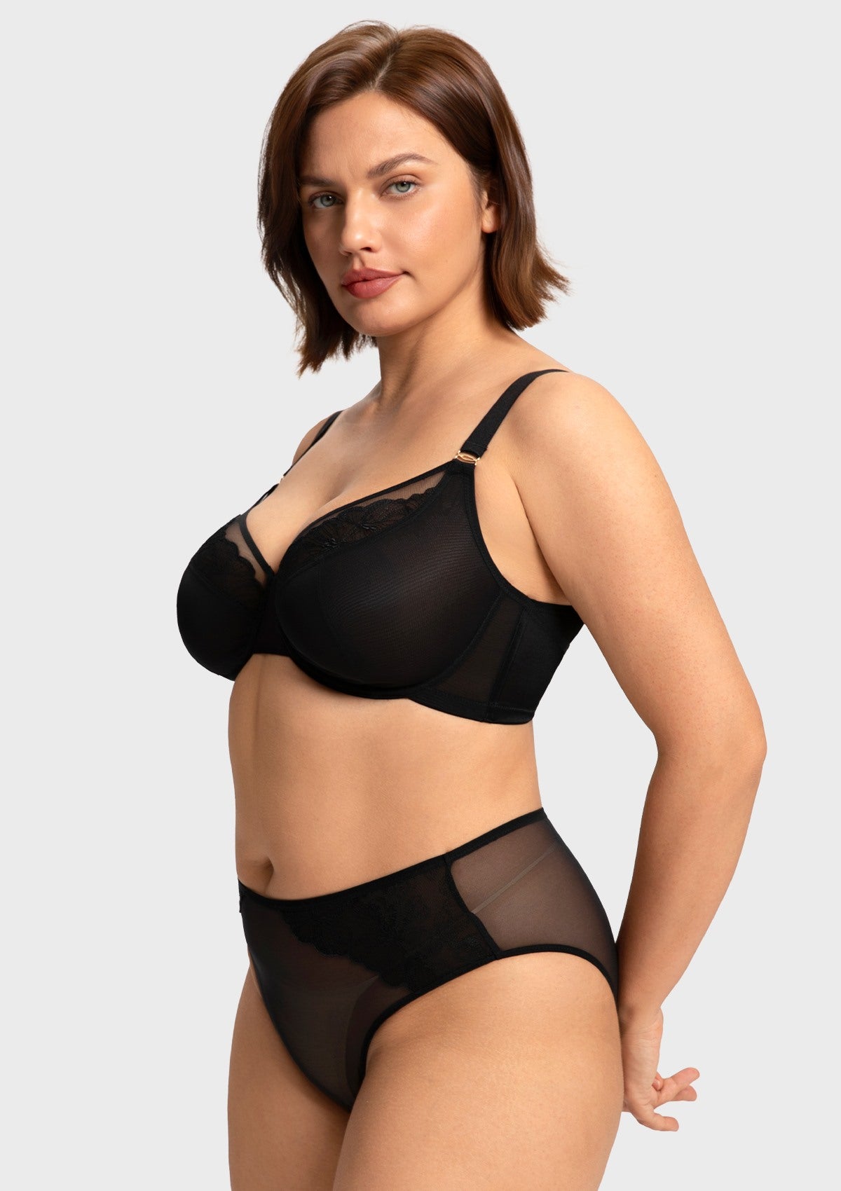 Side angle of the black elegant sculpting bra on model, featuring a rigid mesh lining that provides a naturally sculpted shape and forward projection.