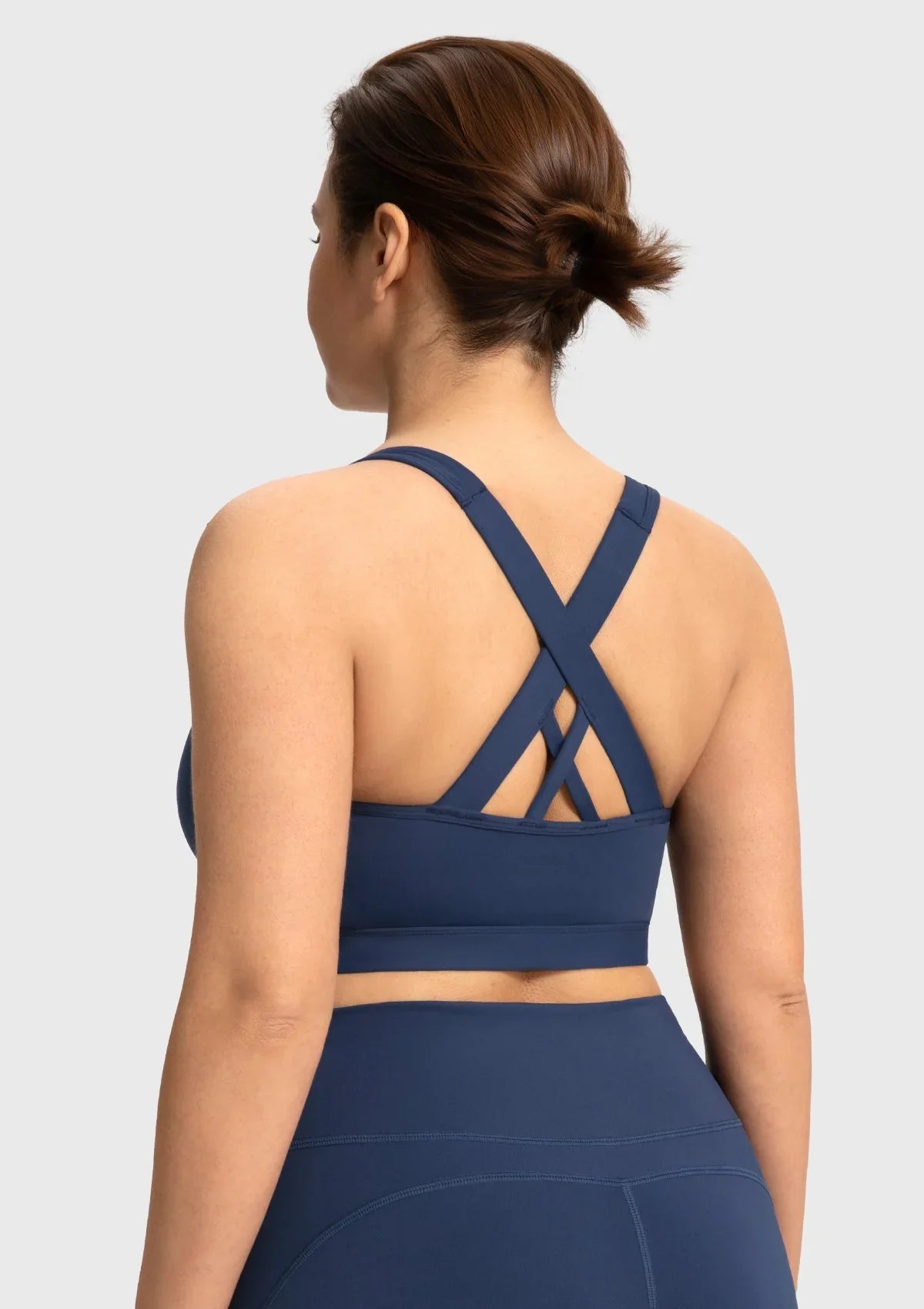 Back view of the navy blue yoga bra featuring strappy criss-cross design for maximum mobility