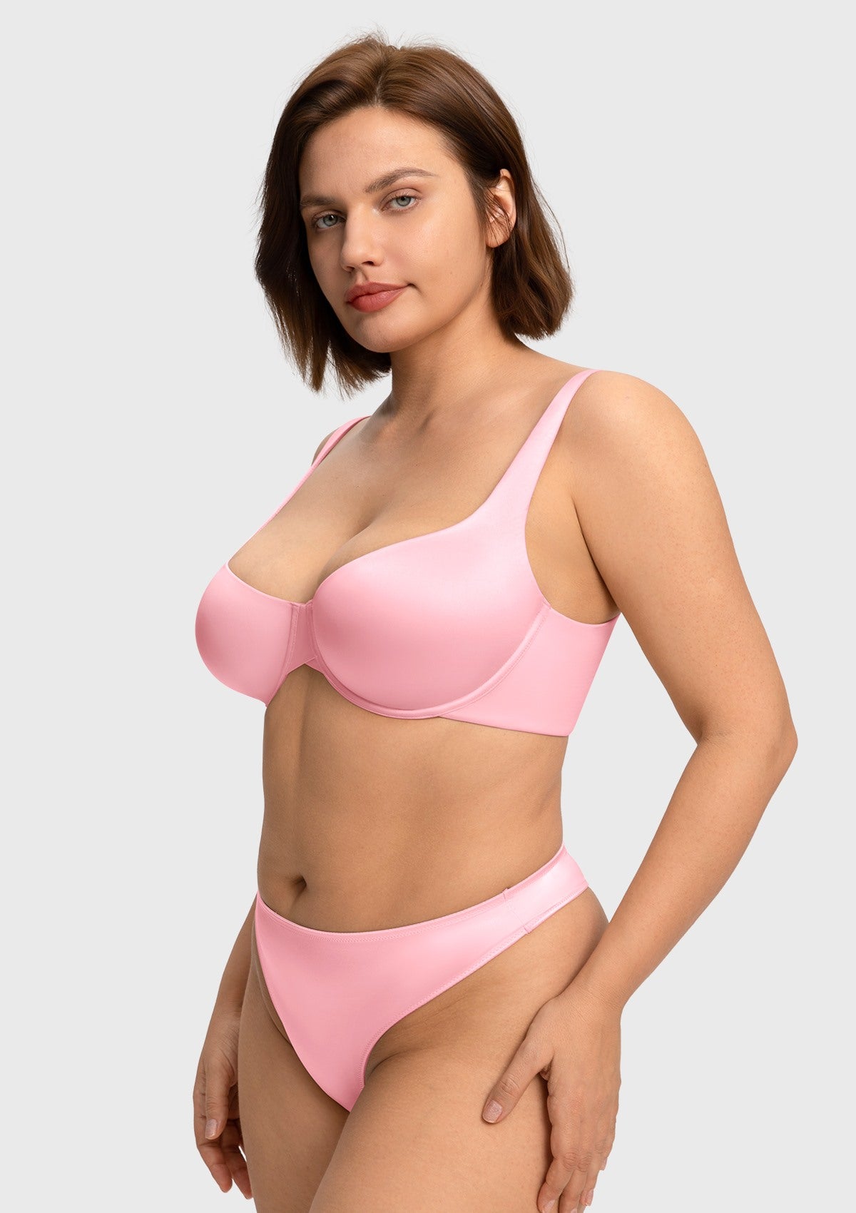 Woman posing in the Victoria pink bandless balconette bra, enjoying lightweight comfort and total freedom from ribcage pressure.