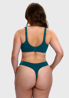 A woman shown from the back wearing a matching teal bikini set against a light gray studio background.