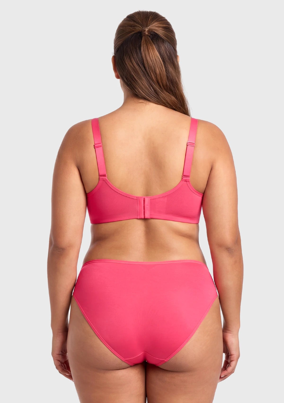 Rear view of the Knockout Pink Seraphina unlined bra on model, highlighting the customized closure system and engineered straps that adapt flawlessly to your bust size.